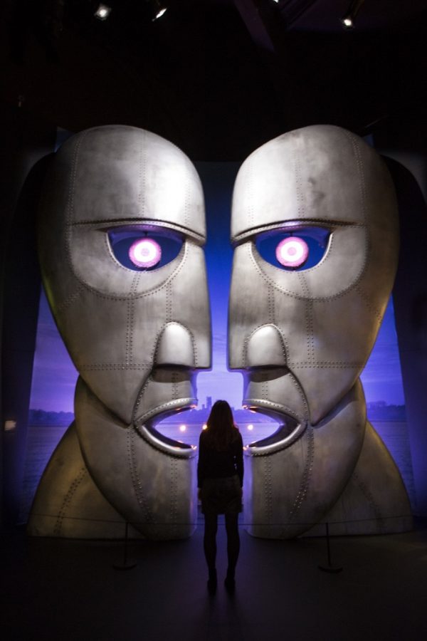 A museum worker poses in front of the metal heads from The Pink Floyd's Division Bell album at the band's exhibition, 'Their Mortal Remains' at the V&A museum in west London, Tuesday, May 9, 2017, an immersive, experimental journey through Pink Floyd's world of over 350 objects and artefacts from the band. The exhibition marks the 50th anniversary of the band's first album, 'The Piper At The Gates Of Dawn' and officially opens to the public on 13 May (Photo by Joel Ryan/Invision/AP)