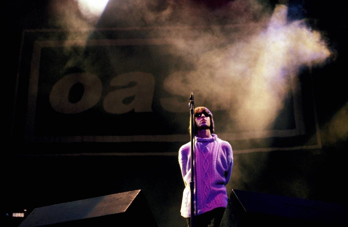 UNITED KINGDOM - AUGUST 01:  KNEBWORTH  Photo of Liam GALLAGHER and OASIS, Liam Gallagher performing live onstage, with Oasis logo behind  (Photo by Roberta Parkin./Redferns)